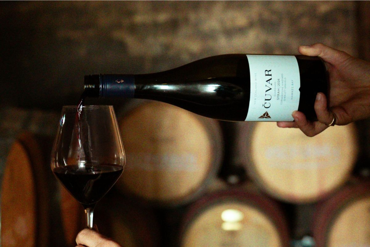 Čuvar Guardians Syrah being poured into a glass in the celllar